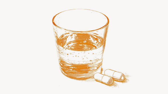 Glass of water and vitamin B12 capsule Everything you need to know about vitamin B12 deficiency