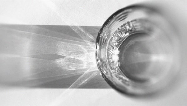 Glass of water Tips for keeping your skin well hydrated in summer